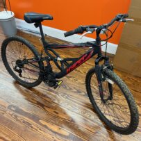Side view of a Hyper Shocker 26 mountain bike showing the steel full‑suspension frame and 26‑inch wheels.