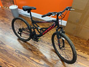 Side view of a Hyper Shocker 26 mountain bike showing the steel full‑suspension frame and 26‑inch wheels.