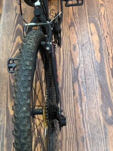 Rear view of a Hyper Shocker 26 mountain bike showing the linear‑pull brakes and rear suspension.