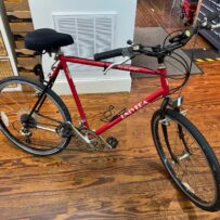 Side view of a vintage Univega Rover Sport bicycle showing the steel frame, drop handlebars, and rear rack.