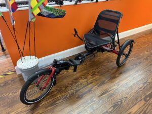 Front view of a Hase Trigo Nexus showing the upright seating, delta frame, and front wheel.