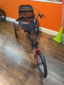Hase Trigo Up recumbent trike, front view with upright seat and steering column.