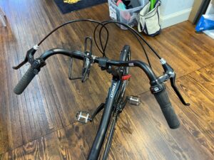 Hase Trigo Up recumbent trike, handlebar view with upright seat and steering column.