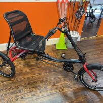 Hase Trigo Up recumbent trike, side view with upright seat and steering column.