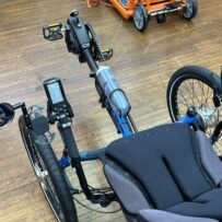 Cockpit view of ICE Adventure recumbent trike rear wheel with 20‑inch tire and Shimano Steps motor.