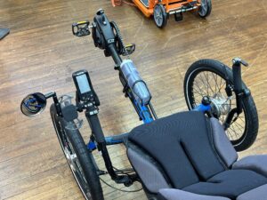 Cockpit view of ICE Adventure recumbent trike rear wheel with 20‑inch tire and Shimano Steps motor.