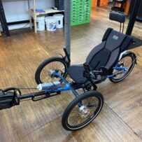 Side view of ICE Adventure recumbent trike rear wheel with 20‑inch tire and Shimano Steps motor.