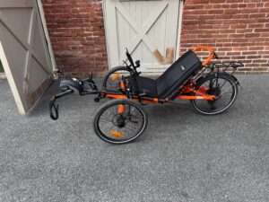 Side view of used Catrike eCAT Villager in Atomic Orange sale at Lancaster Recumbent