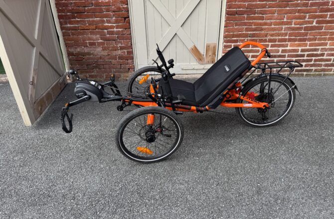 Side view of used Catrike eCAT Villager in Atomic Orange sale at Lancaster Recumbent